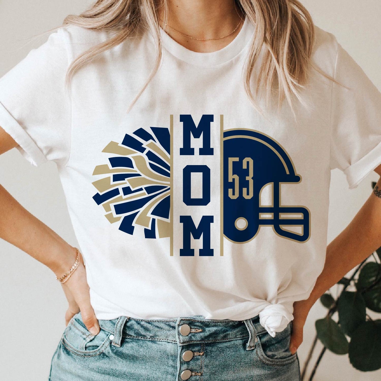 White t-shirt with "Mom" design featuring a football helmet and pom-poms, perfect for football and cheer moms.