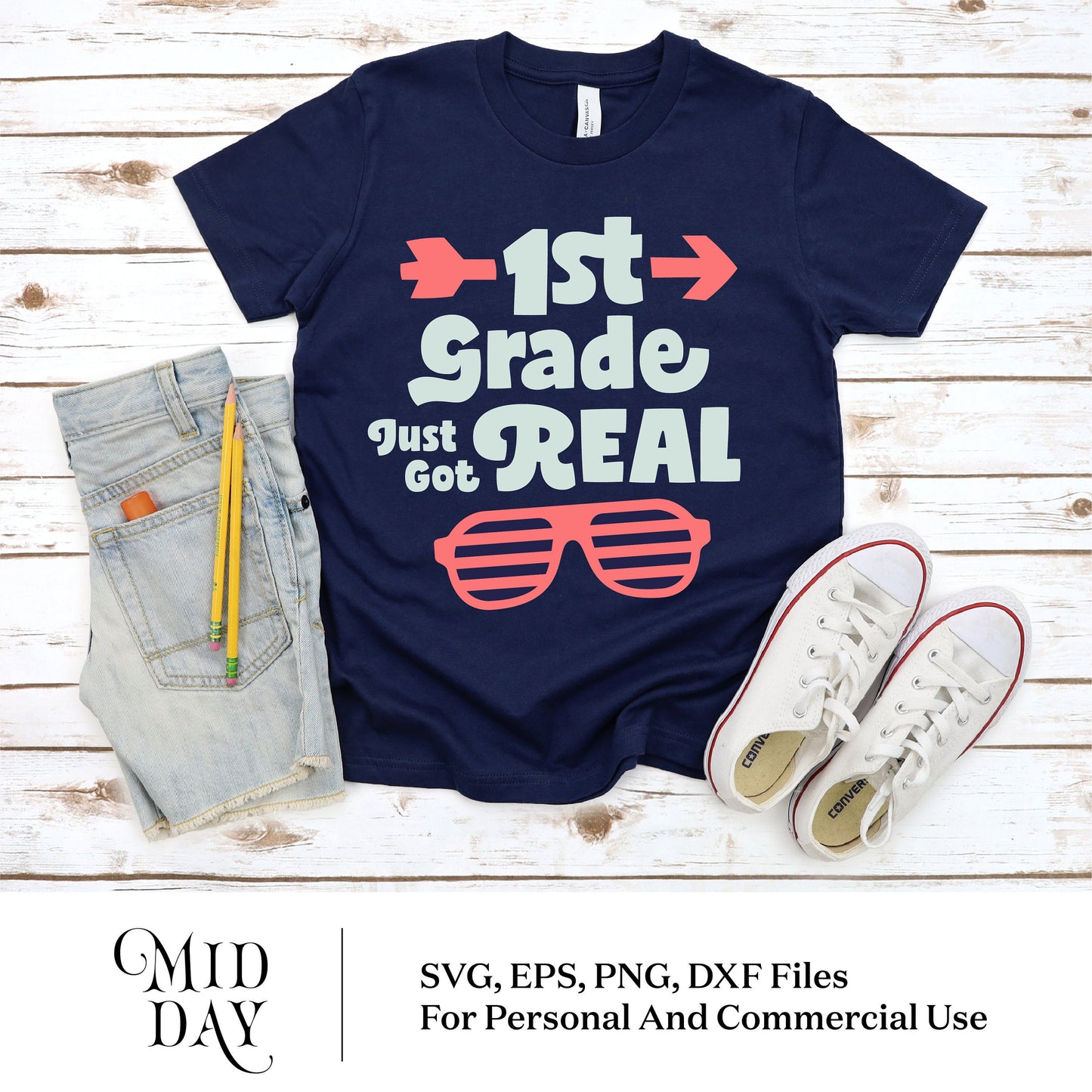 Navy shirt with '1st Grade Just Got Real' design, cut files for Cricut, next to denim shorts and white sneakers, perfect for back to school.