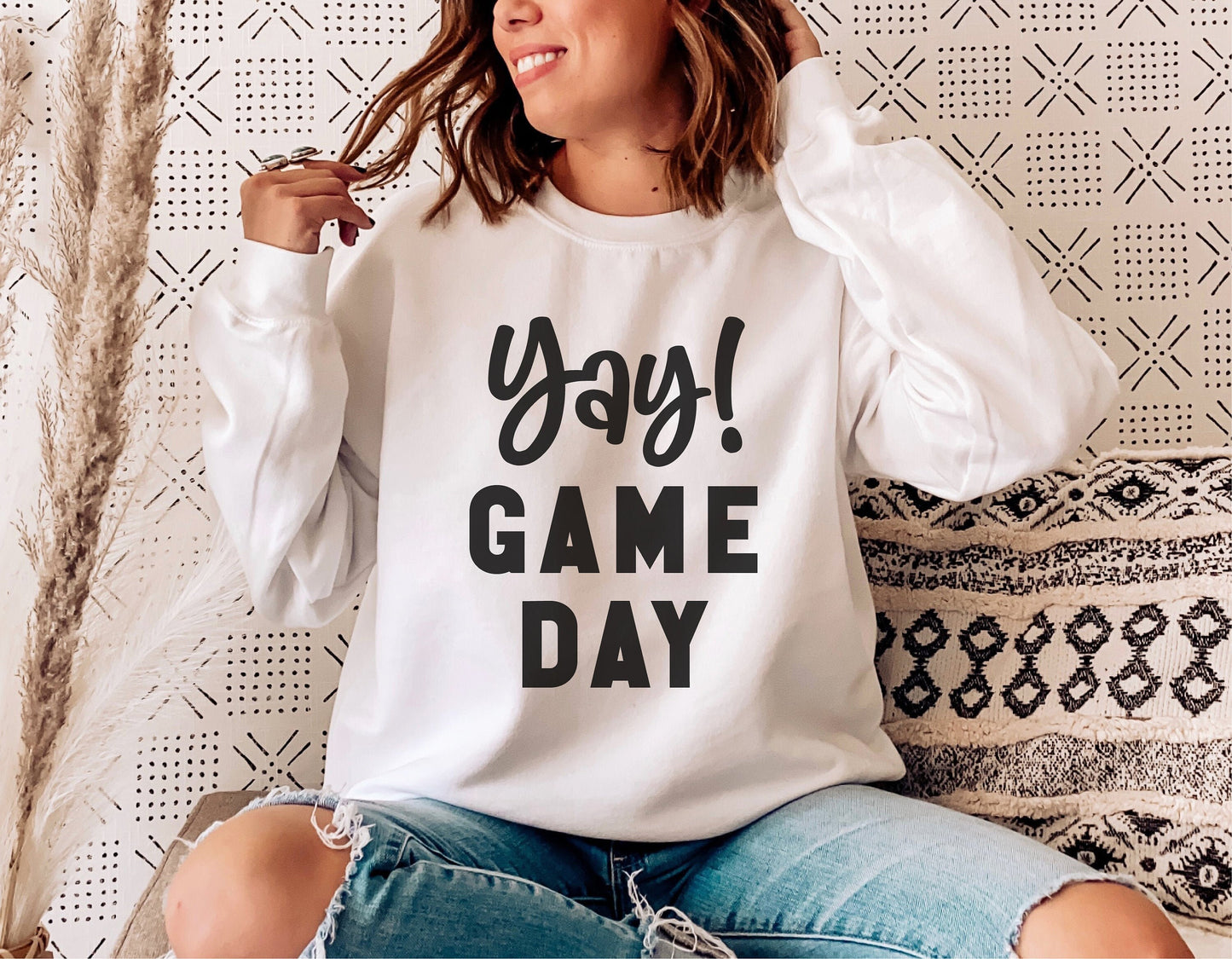 Woman wearing 'Yay! Game Day' sweatshirt, casual cozy style, sports mom fashion.