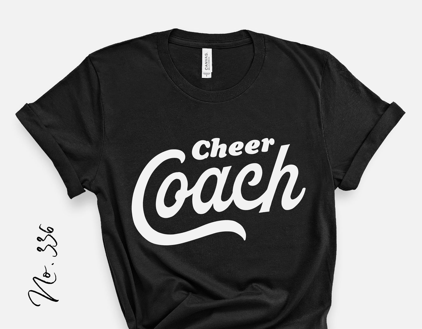 Black Cheer Coach t-shirt with white script design, perfect for cheerleading school spirit and game day fashion.