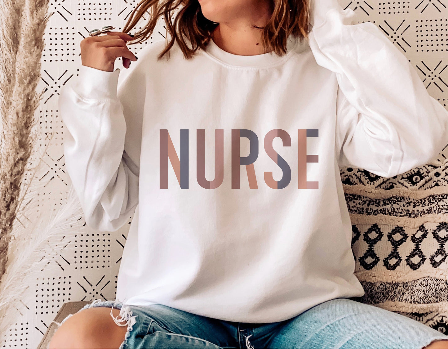 Woman wearing "NURSE" graphic sweatshirt in casual setting, perfect for Nurse Life SVG projects and Cricut cut files.
