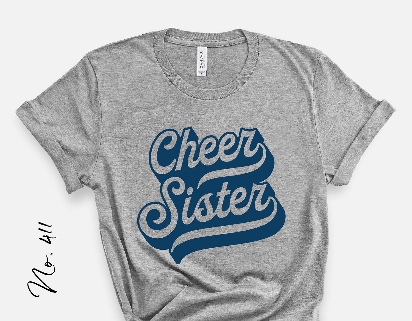 Gray t-shirt featuring a retro cursive 'Cheer Sister' design, perfect for cheerleader team spirit. Available as SVG, PNG, EPS, and DXF.