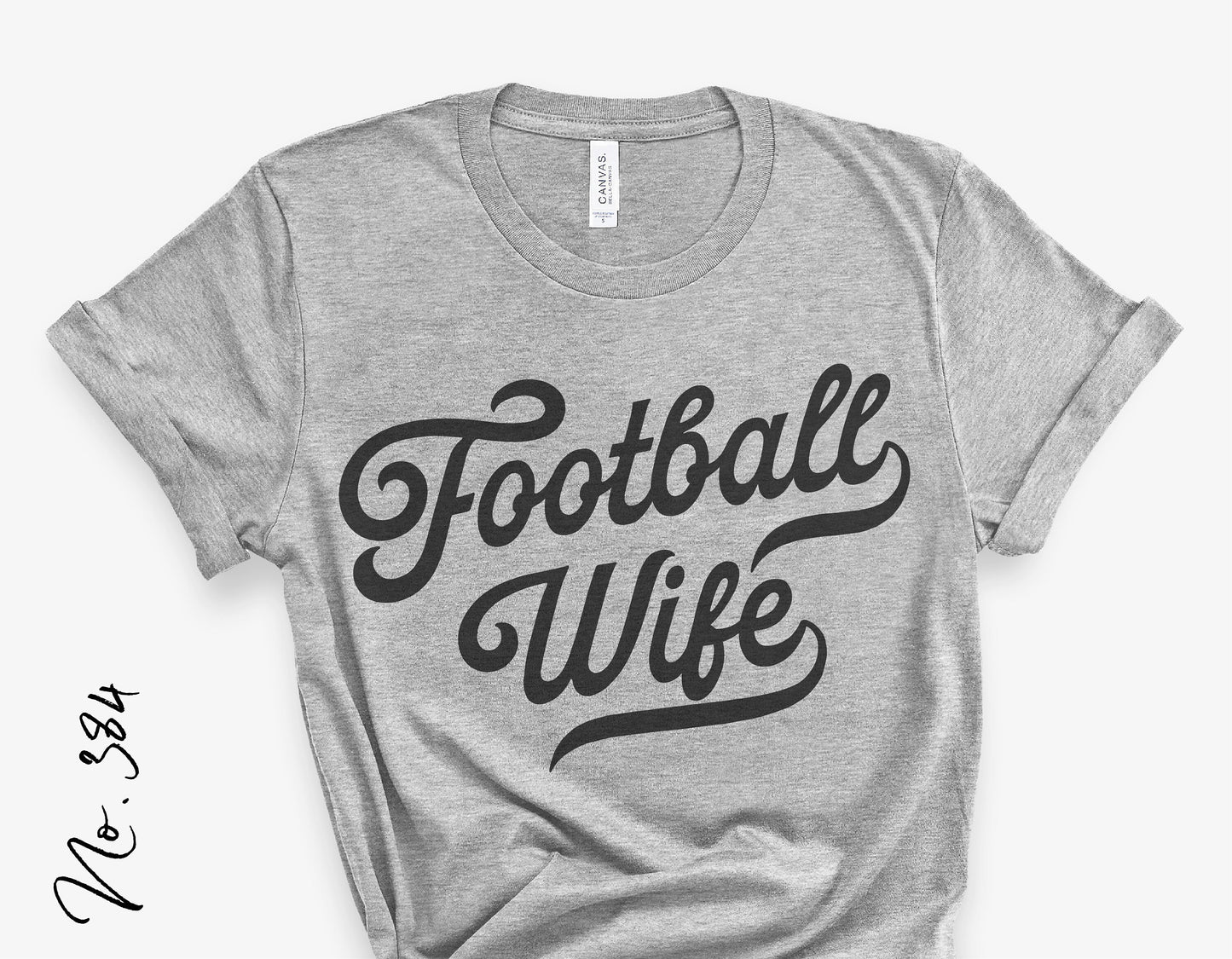 Gray t-shirt with "Football Wife" design in black script, perfect for vintage football fans and sports enthusiasts.