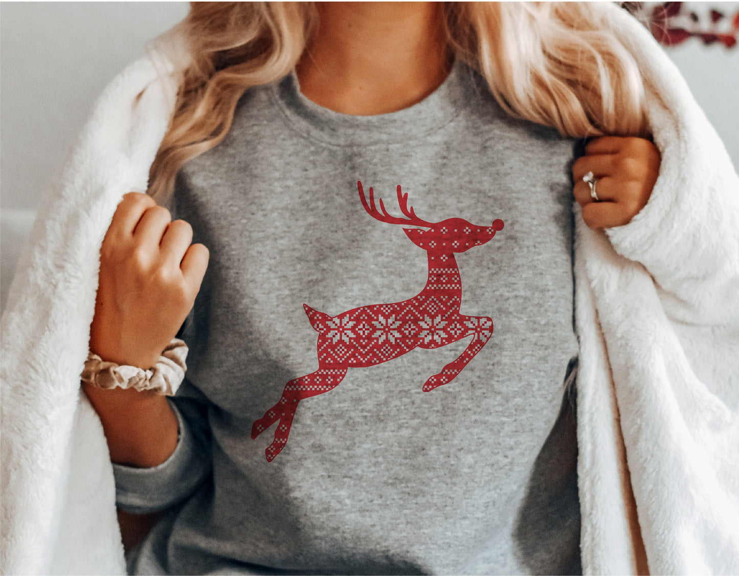 Person wearing a sweater with red patterned reindeer design, perfect for Christmas and winter themes, suitable for Cricut and Silhouette projects.
