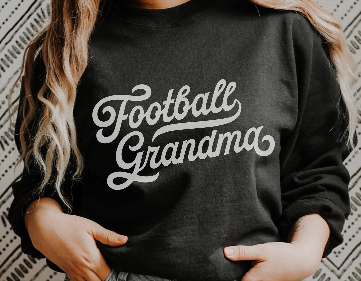Person wearing a black sweatshirt with 'Football Grandma' text, ideal for vintage sports style and Cricut Silhouette projects.