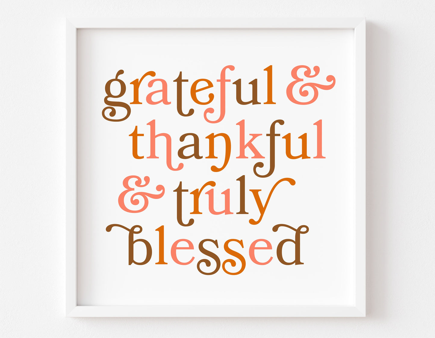 Framed artwork with the text 'grateful & thankful & truly blessed' in autumn colors.