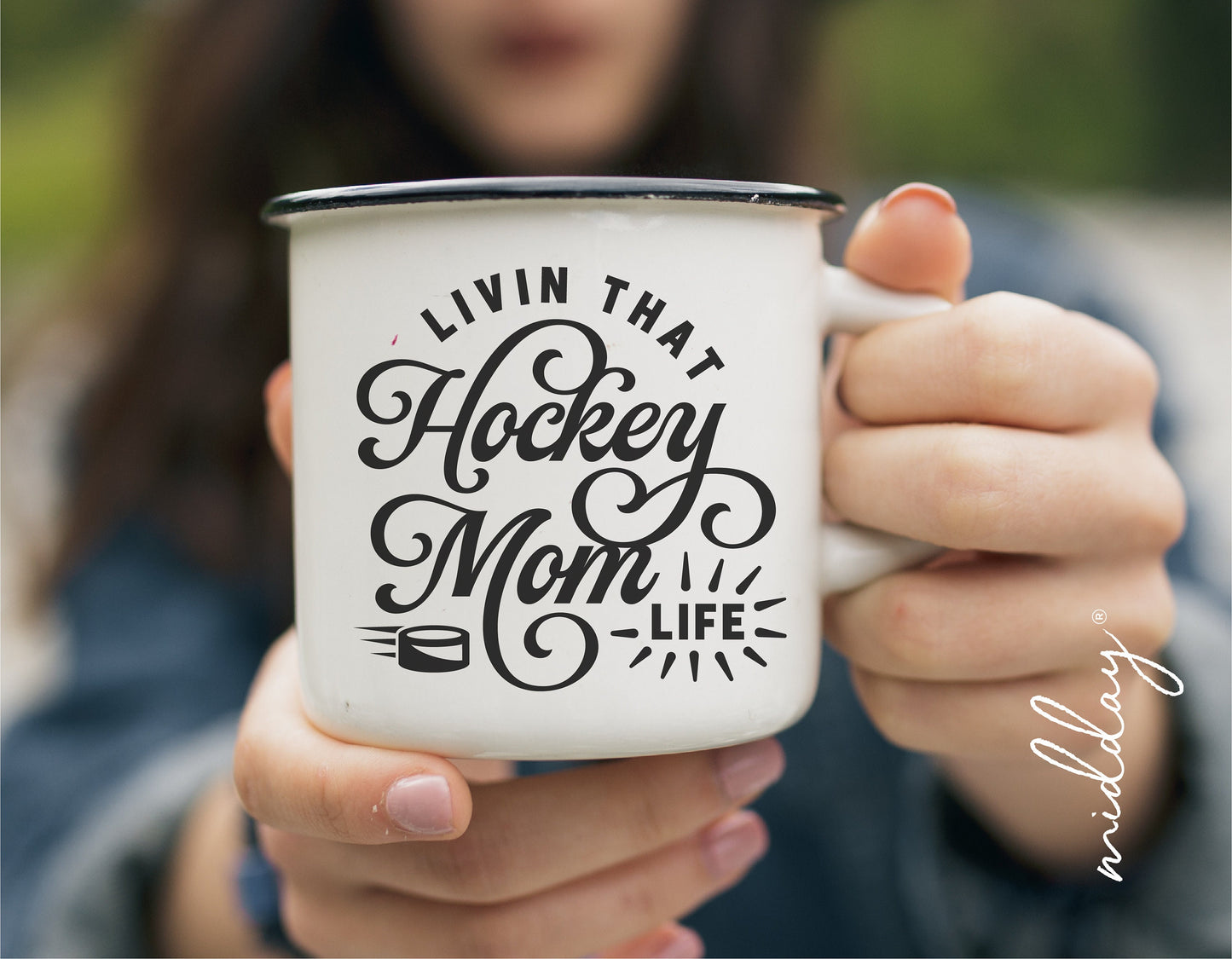 "Livin That Hockey Mom Life" mug held by a person outdoors, perfect for hockey moms and fans, ideal for Cricut and Silhouette crafting.