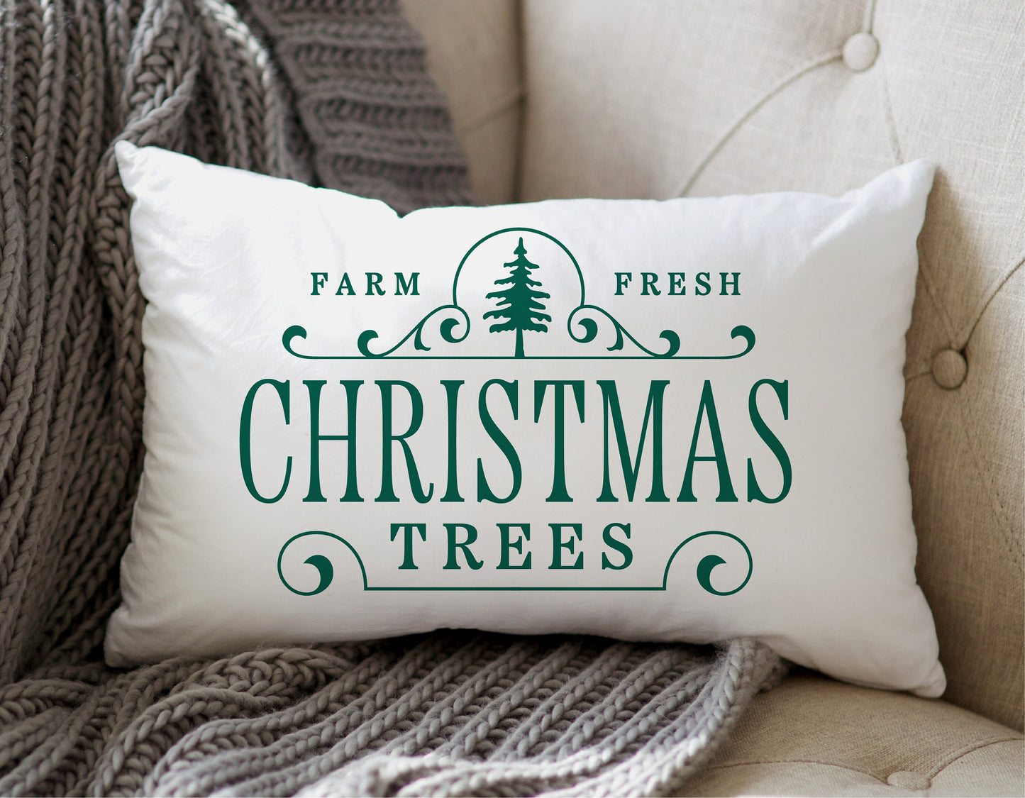 Farm Fresh Christmas Trees decorative pillow on a beige couch with gray knit throw blanket, holiday decor inspiration.