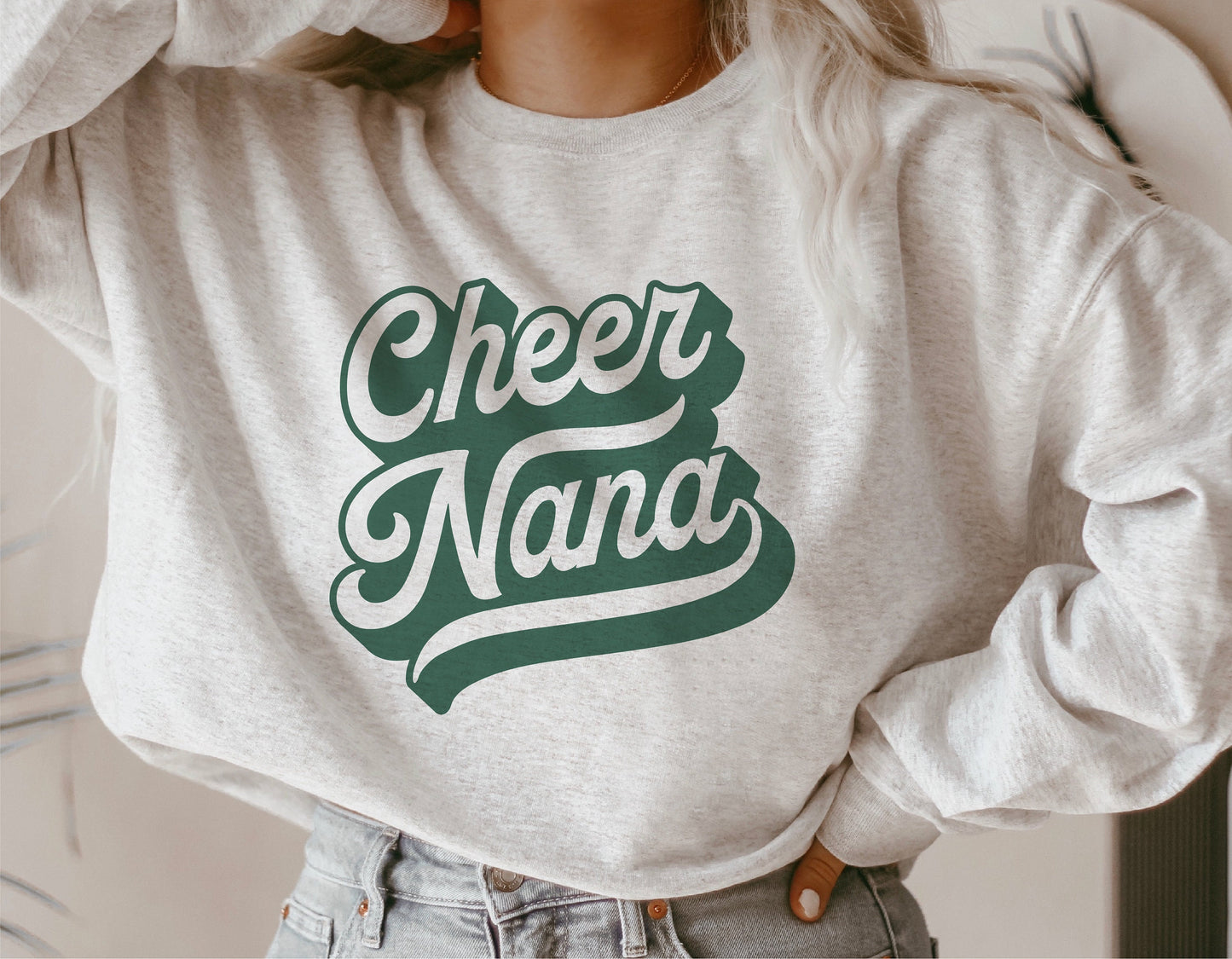 "Cheer Nana" text on a gray sweatshirt, showcasing team spirit design for grandmothers, ideal for Cricut and Silhouette crafts.