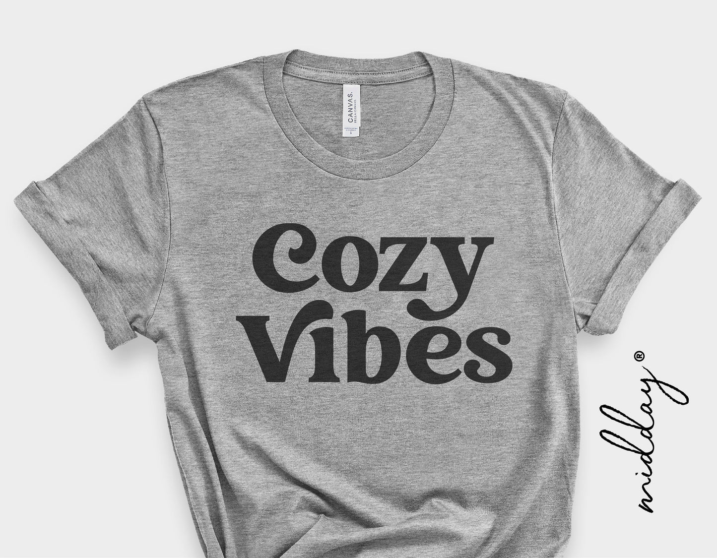 Gray t-shirt with 'Cozy Vibes' text, showcasing retro typography style, perfect for cozy autumn and winter fashion.