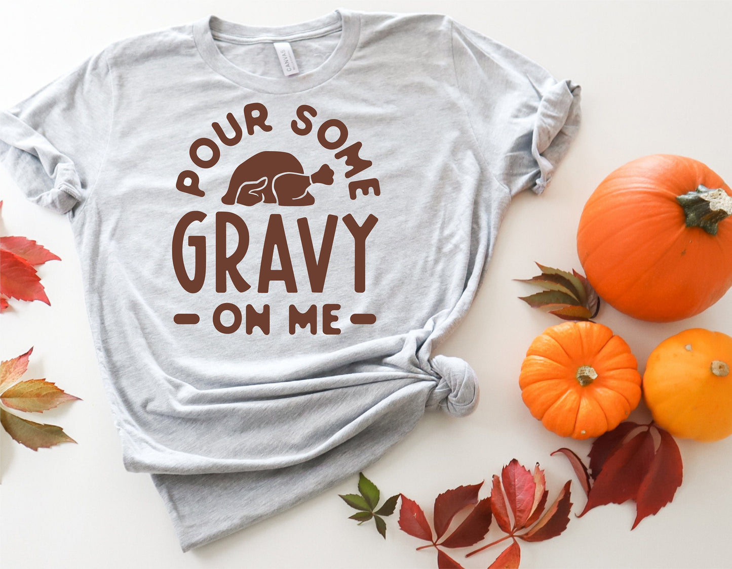 Funny Thanksgiving shirt with 'Pour Some Gravy on Me' design, surrounded by pumpkins and autumn leaves, perfect for Cricut and Silhouette.