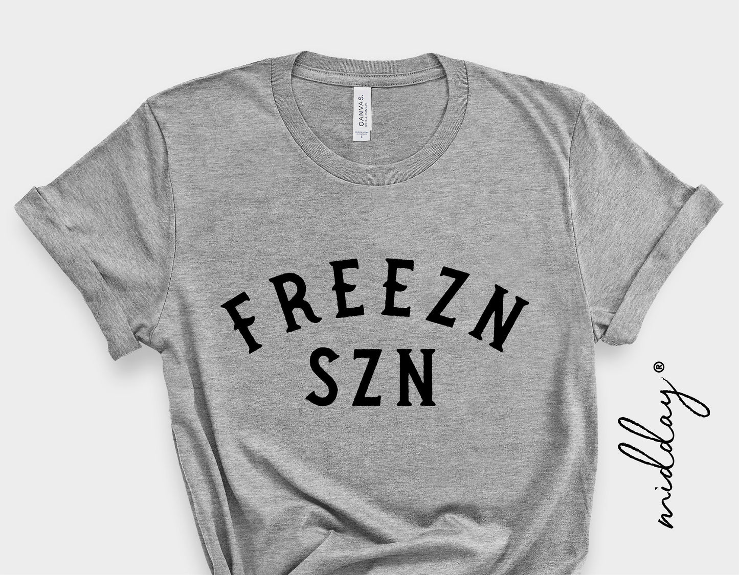 Gray t-shirt with "FREEZN SZN" text, ideal for winter fashion and holiday-themed gifts.