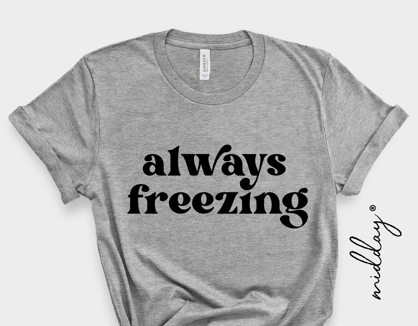 Gray t-shirt with 'always freezing' text, perfect for winter and holiday humor, ideal for Cricut and sublimation projects.