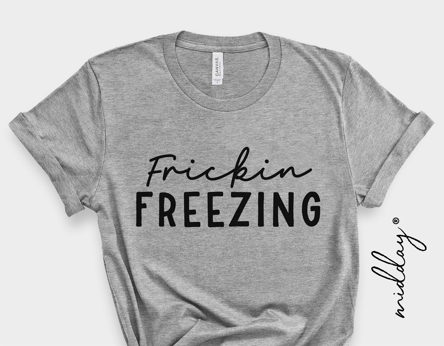 Gray t-shirt with 'Frickin Freezing' text, suitable for winter fashion or holiday gift ideas.