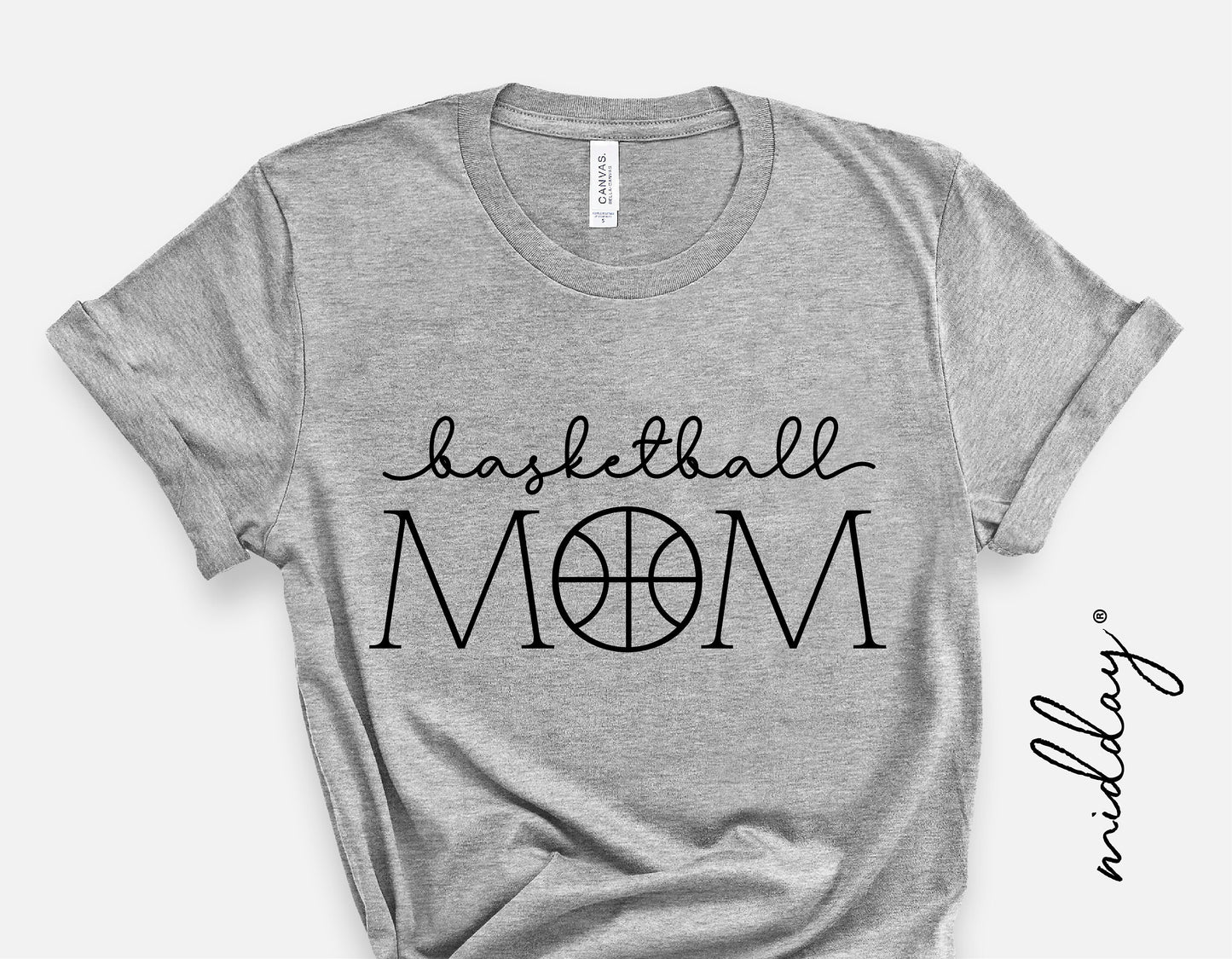 Gray t-shirt with 'Basketball Mom' design featuring basketball-themed lettering, ideal for sports moms or basketball fans.