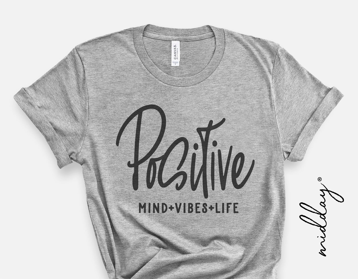 Gray t-shirt with 'Positive Mind Vibes Life' design in black script; inspirational SVG for Cricut crafting.