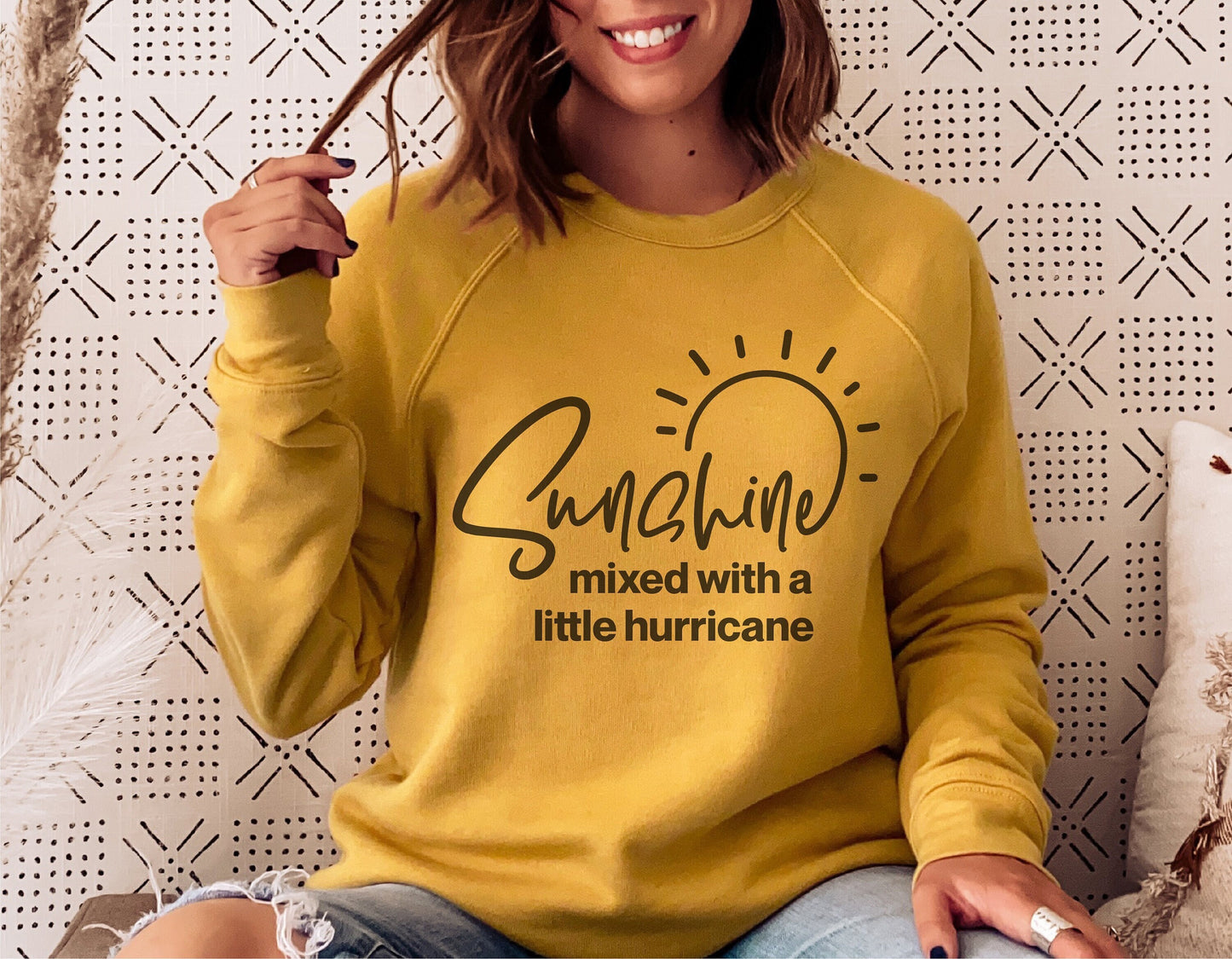 Woman wearing a yellow sweater with 'Sunshine mixed with a little hurricane' text, casual outfit, funny silhouette design for Cricut.