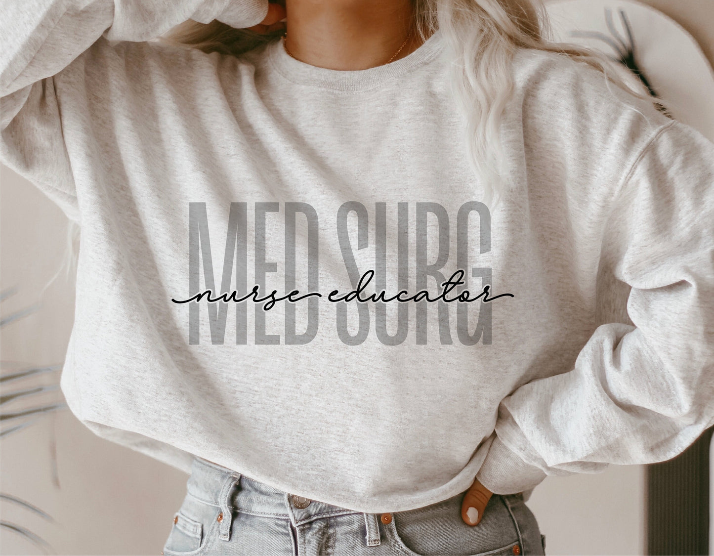 Woman wearing a grey sweatshirt with 'Med Surg Nurse Educator' design, perfect for medical professionals and Cricut projects.