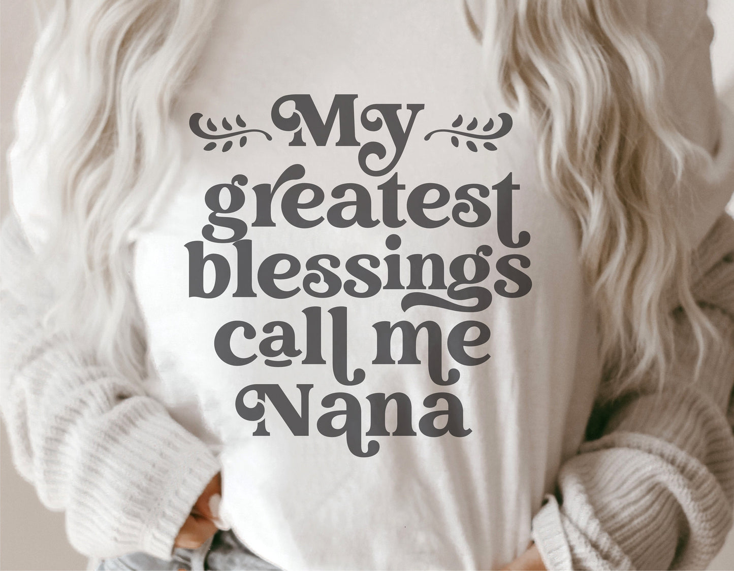 Woman wearing 'My Greatest Blessings Call Me Nana' shirt, ideal for Mother's Day gifts, featuring Cricut and Silhouette compatible design.