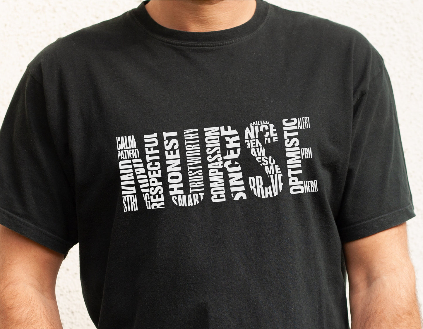 Black t-shirt with word art spelling 'Nurse' using words like compassionate, respectful, honest, and optimistic.