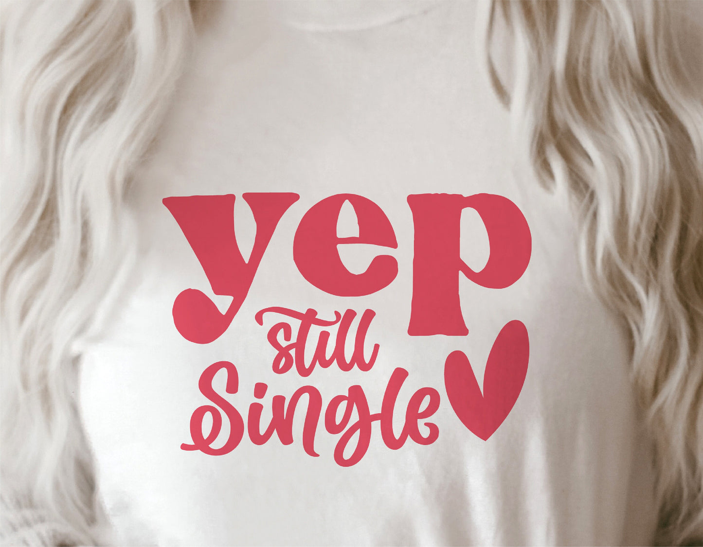 White t-shirt with 'Yep, Still Single' in red text, worn by person with long blonde hair, humorous Valentine's Day design.