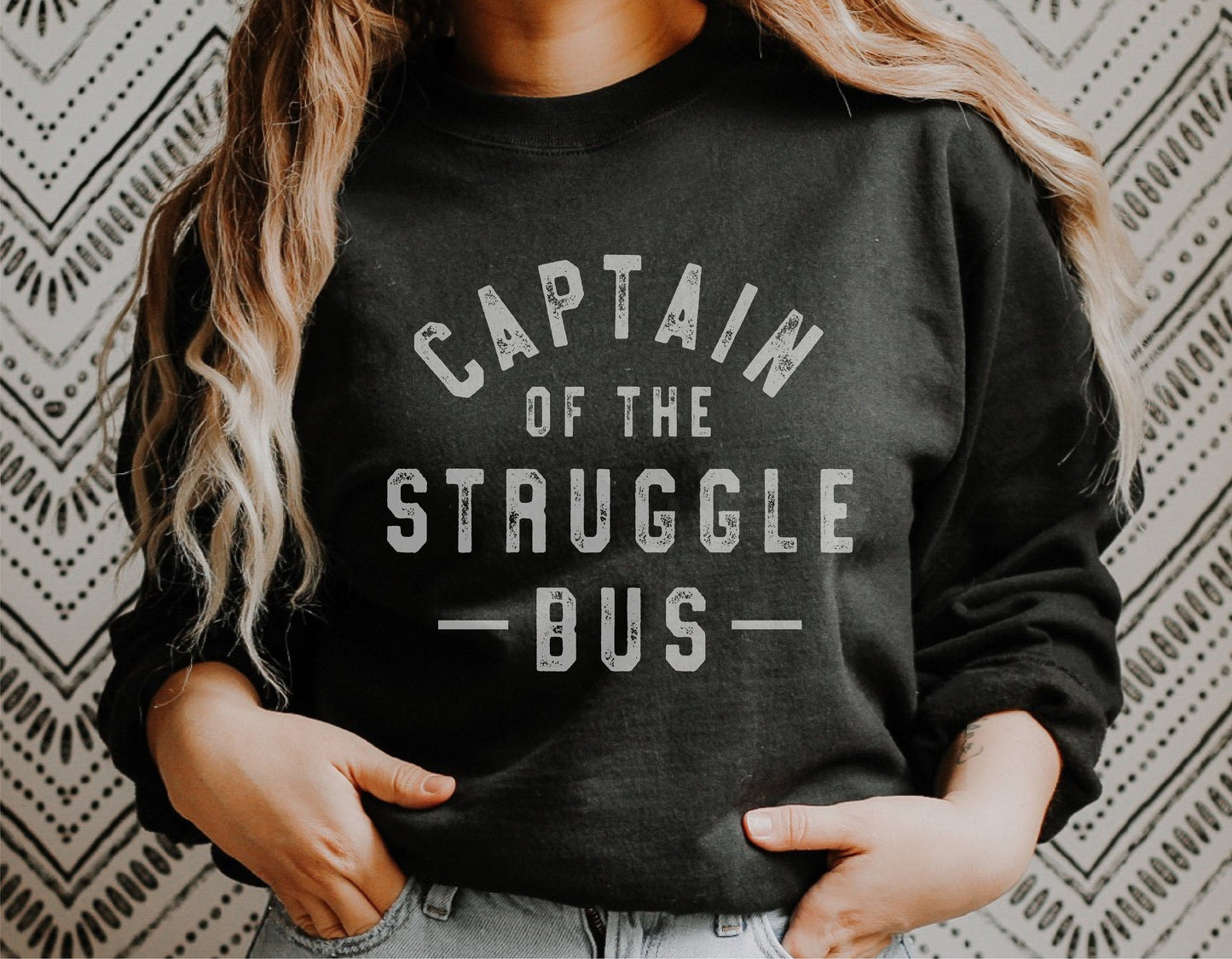 Woman wearing a black sweatshirt with 'Captain of the Struggle Bus' text, showcasing a funny sarcastic design for Cricut or Silhouette projects.