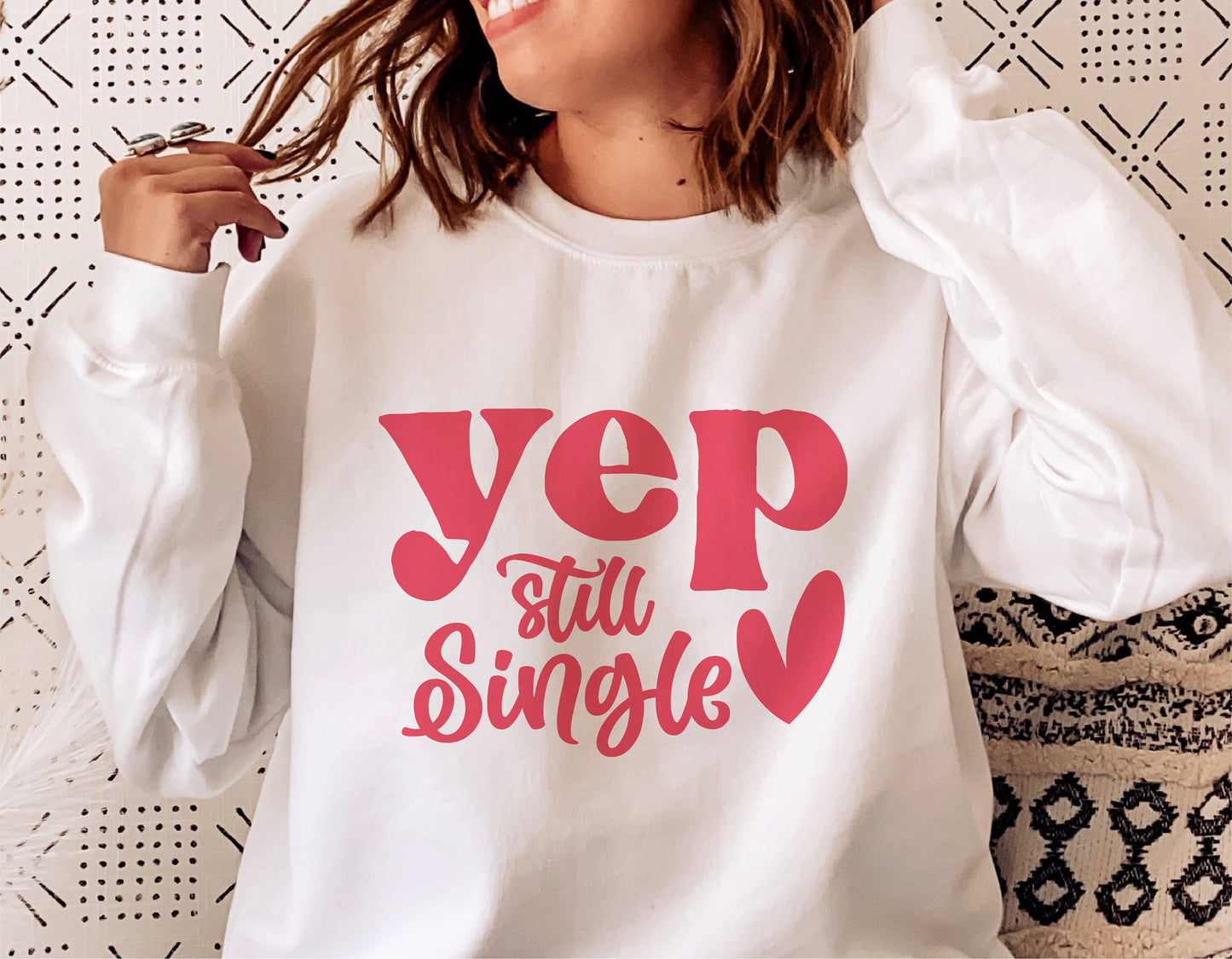 Woman wearing a white sweatshirt with "Yep Still Single" and heart design, ideal for Valentine's Day or funny gift SVG cut file.