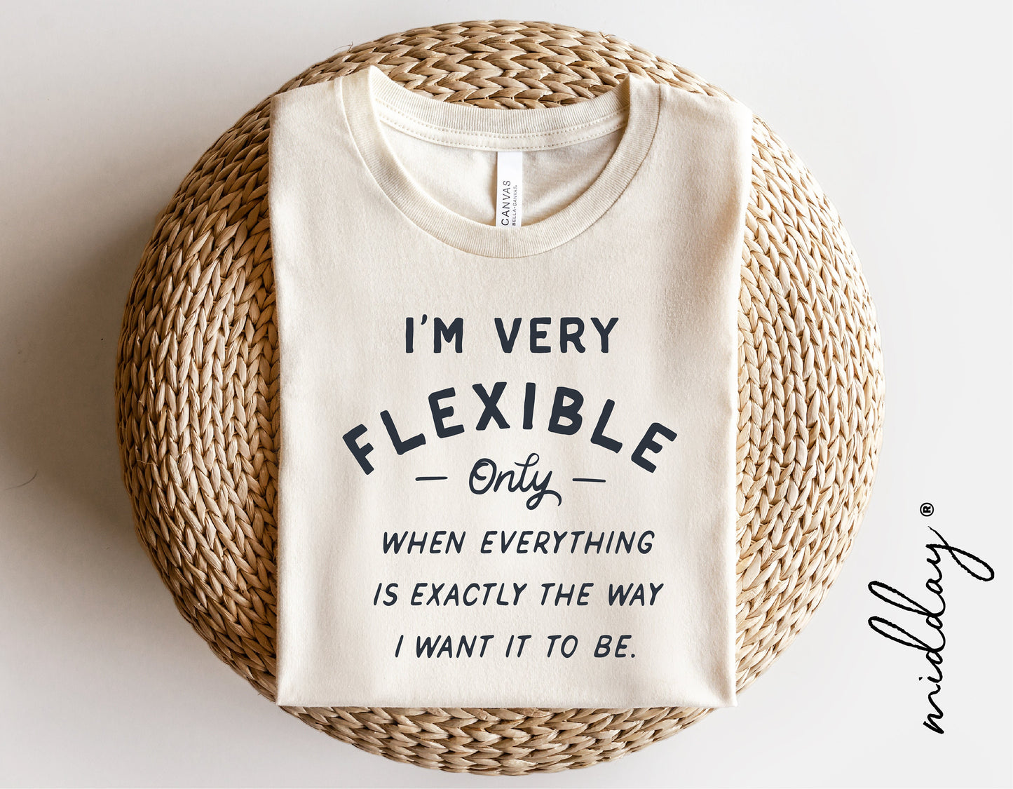 Funny cream t-shirt with 'I'm Very Flexible' text, showcasing sarcastic humor, ideal for mom boss babe style, laid on woven mat.