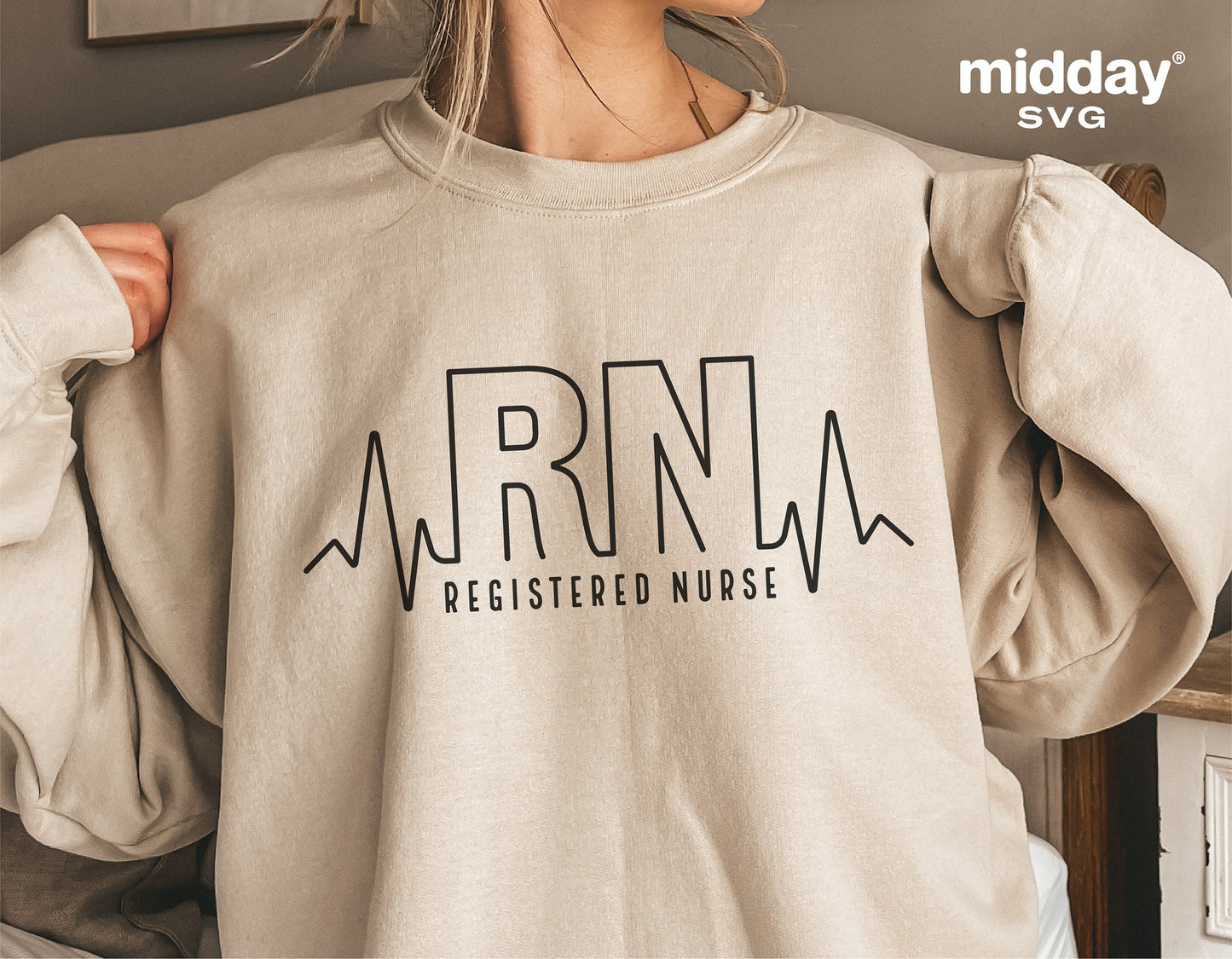 Woman wearing beige sweatshirt with 'RN Registered Nurse' and heartbeat design, perfect for nurse apparel and Cricut cut files.