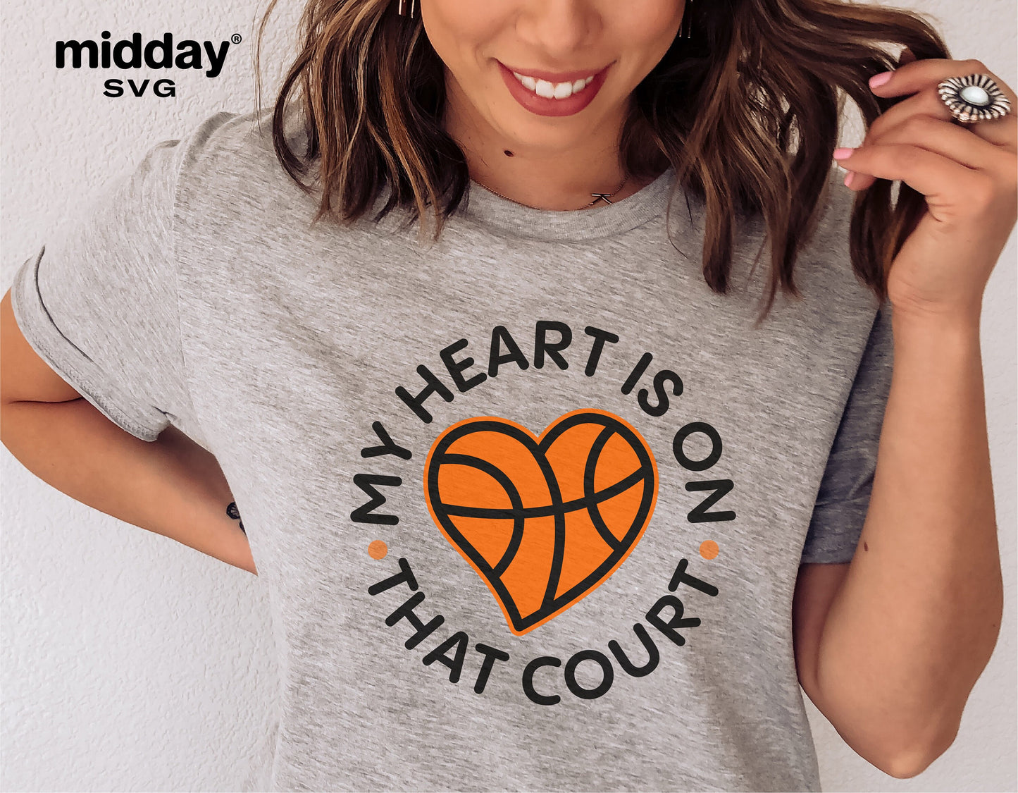 Woman wearing a grey t-shirt with 'My Heart is on That Court' basketball logo, ideal for basketball moms, compatible with Cricut and Silhouette.