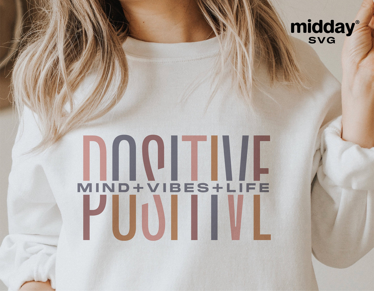 Woman wearing a sweatshirt with 'Positive Mind Vibes Life' design, showcasing motivational and self-love SVG graphics.