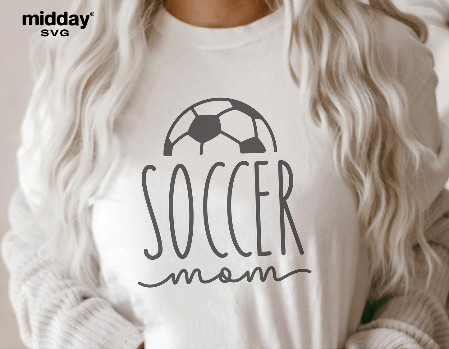 Woman wearing a white t-shirt with 'Soccer Mom' text and soccer ball graphic design.