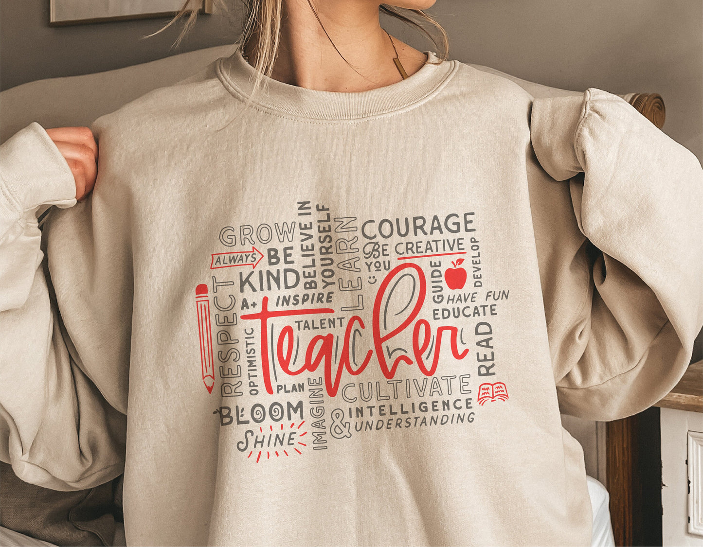 Cozy beige sweater featuring a unique teacher word art design, perfect for teacher appreciation and custom decoration projects.