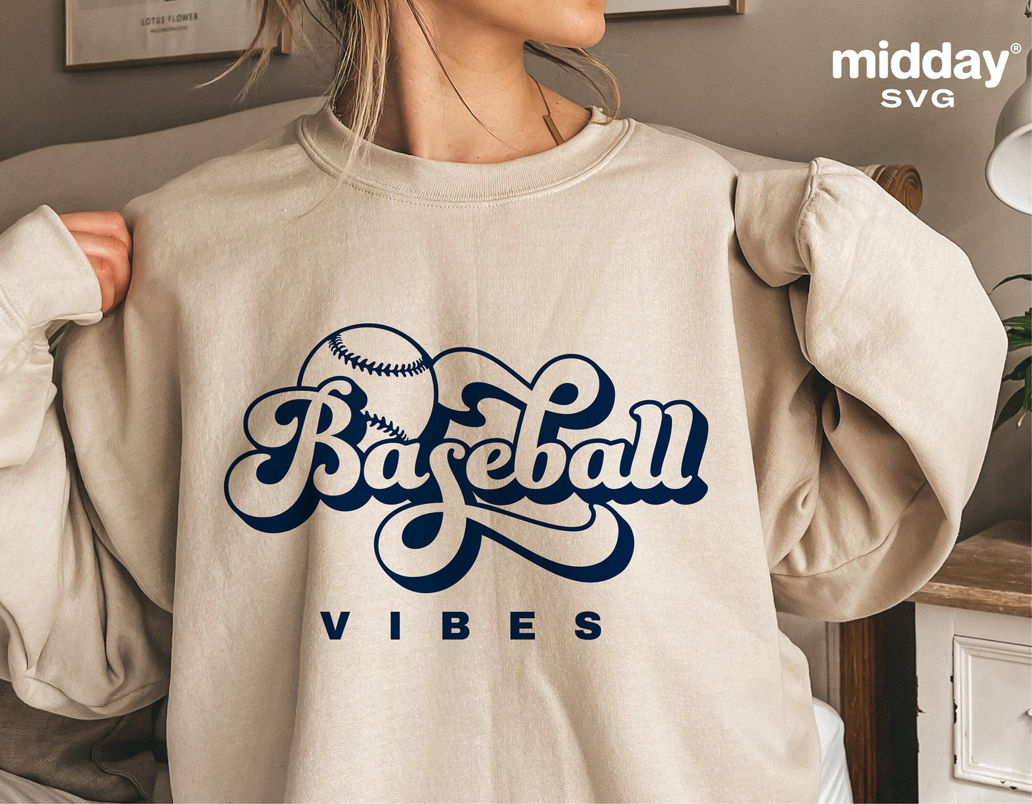 Woman wearing a beige sweatshirt with 'Baseball Vibes' and a baseball graphic, perfect for retro Cricut projects and sublimation.