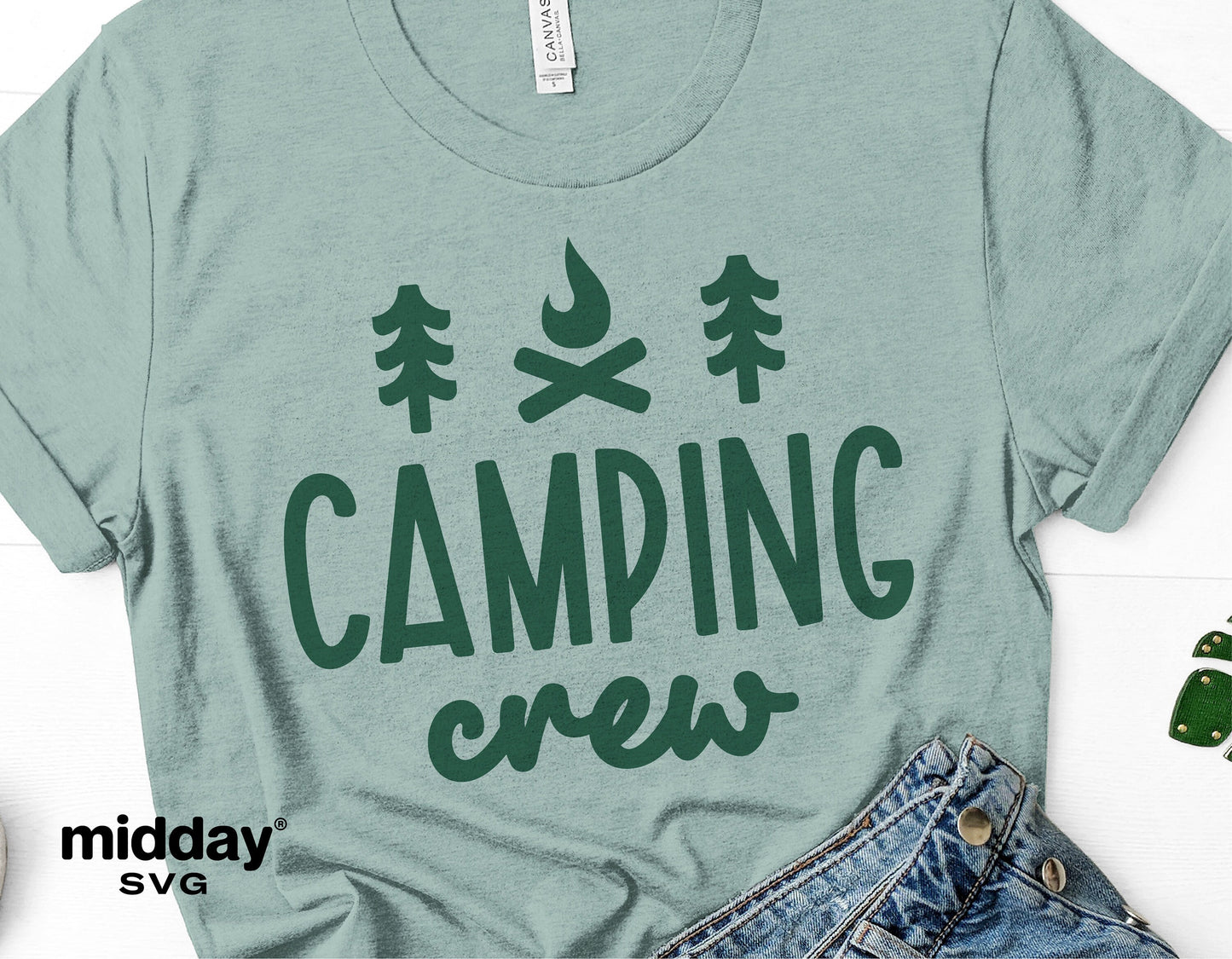 Green t-shirt with 'Camping Crew' design featuring pine trees and a campfire graphic, ideal for camping enthusiasts and outdoor adventures.