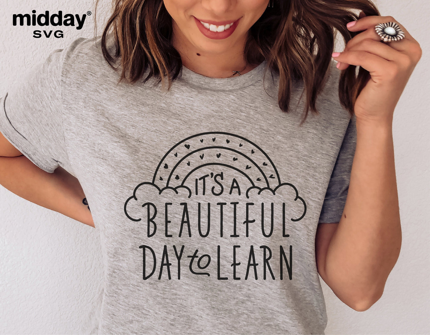 Woman wearing a "It's A Beautiful Day To Learn" teacher shirt with stylish text and rainbow design, ideal for teaching-themed projects.