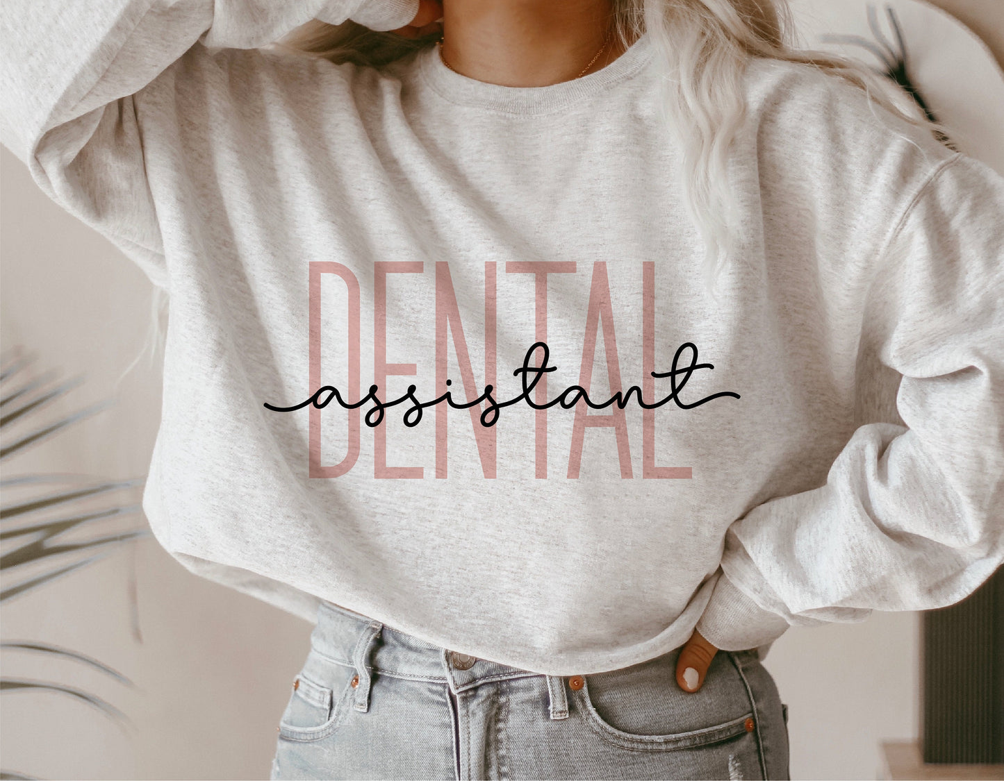Person wearing a gray sweatshirt with 'Dental Assistant' text design suitable for Cricut and Silhouette projects.
