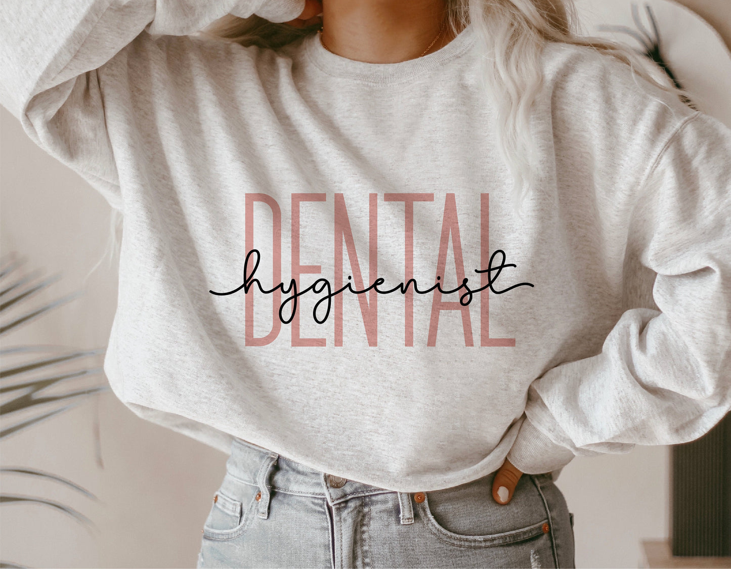 Woman wearing a sweatshirt with 'Dental Hygienist' text design, ideal for dental professionals, Cricut and Silhouette crafting.