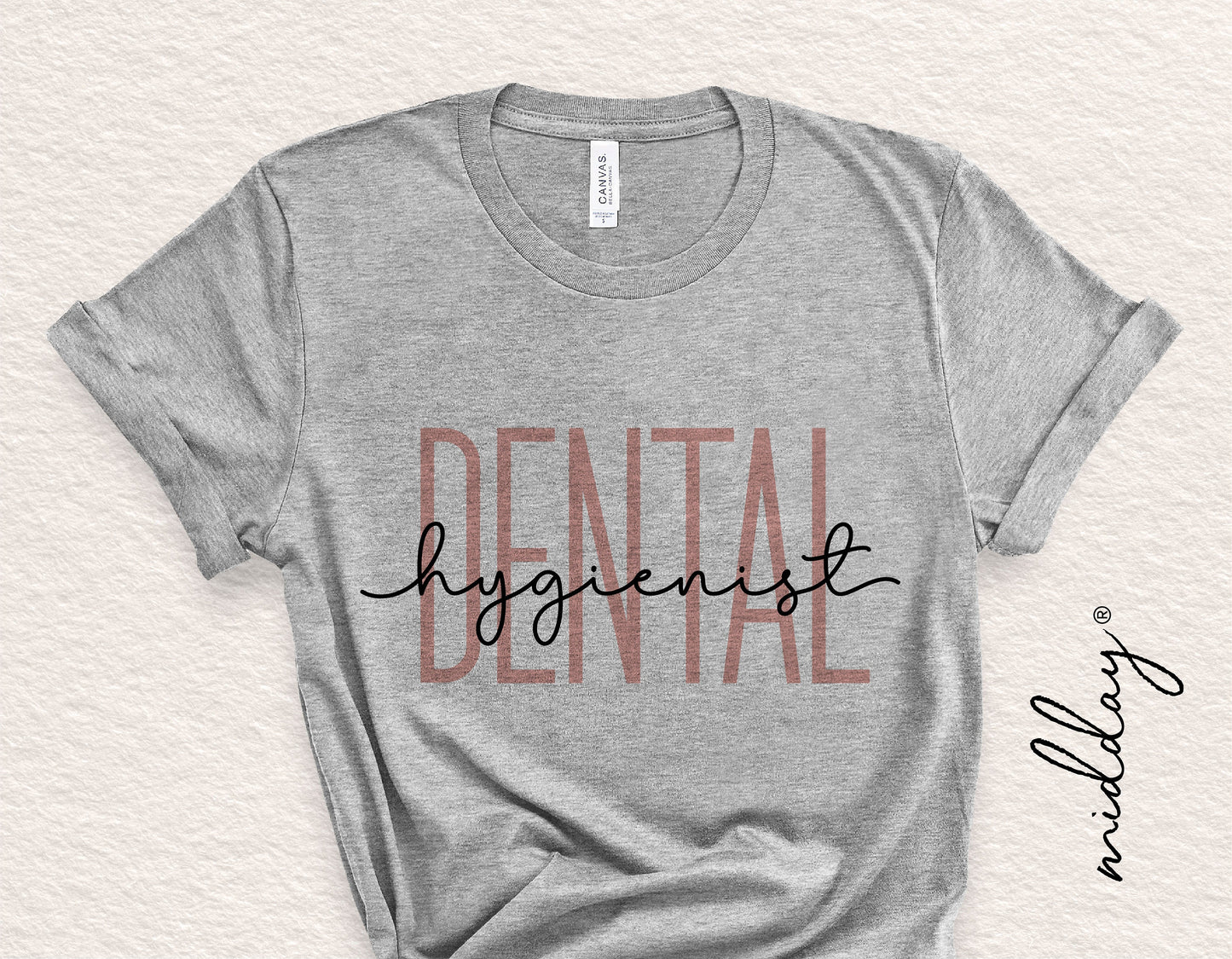 Gray t-shirt with 'Dental Hygienist' design in large printed text, ideal for dental professionals, compatible with Cricut and Silhouette cutting.