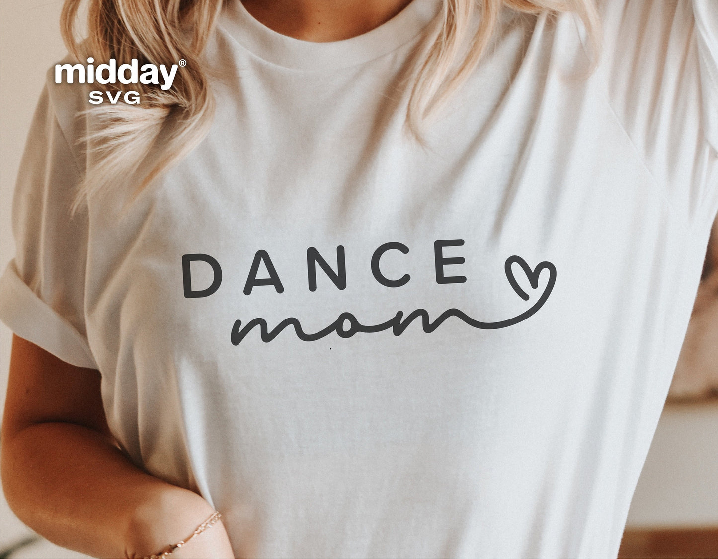 Woman wearing a white 'Dance Mom' shirt, perfect for dance enthusiasts, available as SVG cut file for Cricut and Silhouette.