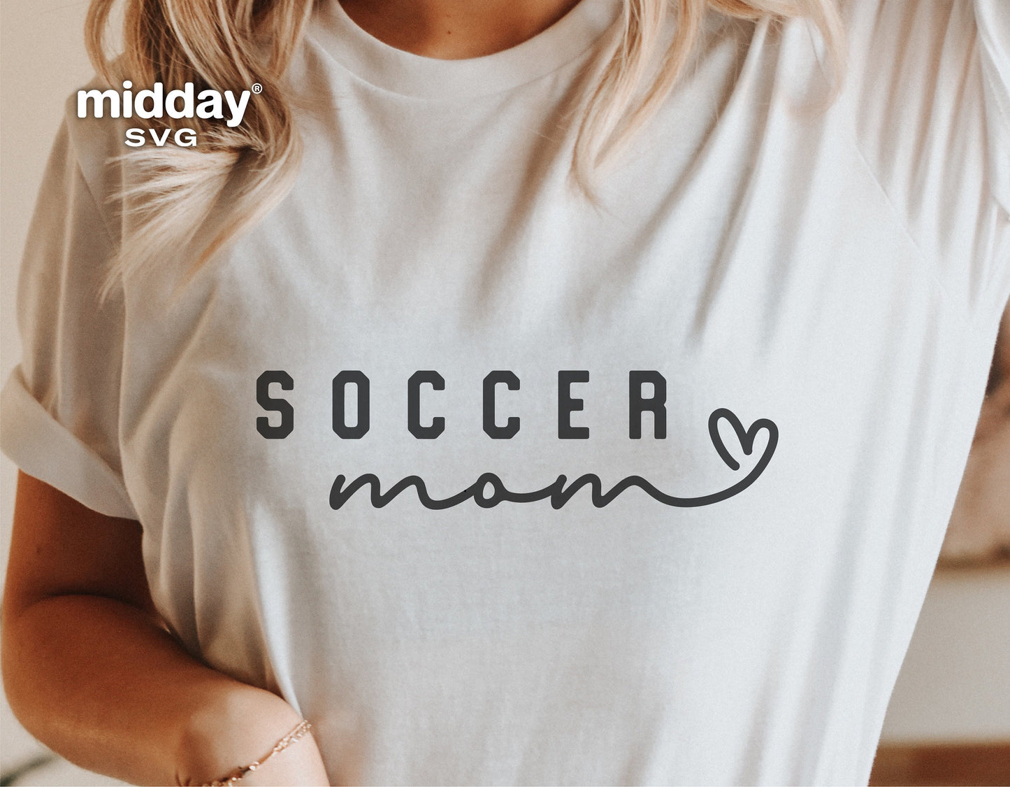 Woman wearing a white t-shirt with 'Soccer Mom' print, showcasing soccer mom SVG design for Cricut and Silhouette projects.