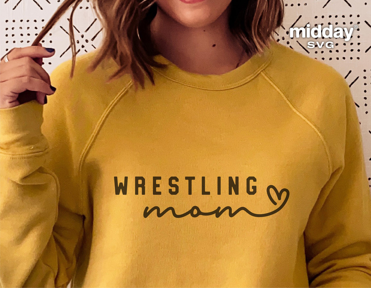 Woman wearing yellow sweatshirt with 'Wrestling Mom' SVG design, ideal for Cricut and Silhouette projects.