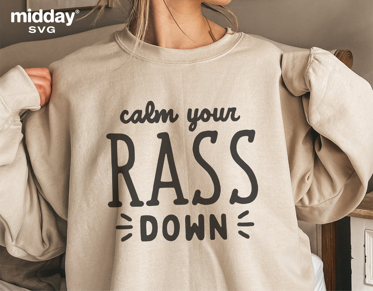 Person wearing sweatshirt with 'Calm Your RASS Down' design, perfect for nurses. SVG design for Cricut and Silhouette projects.