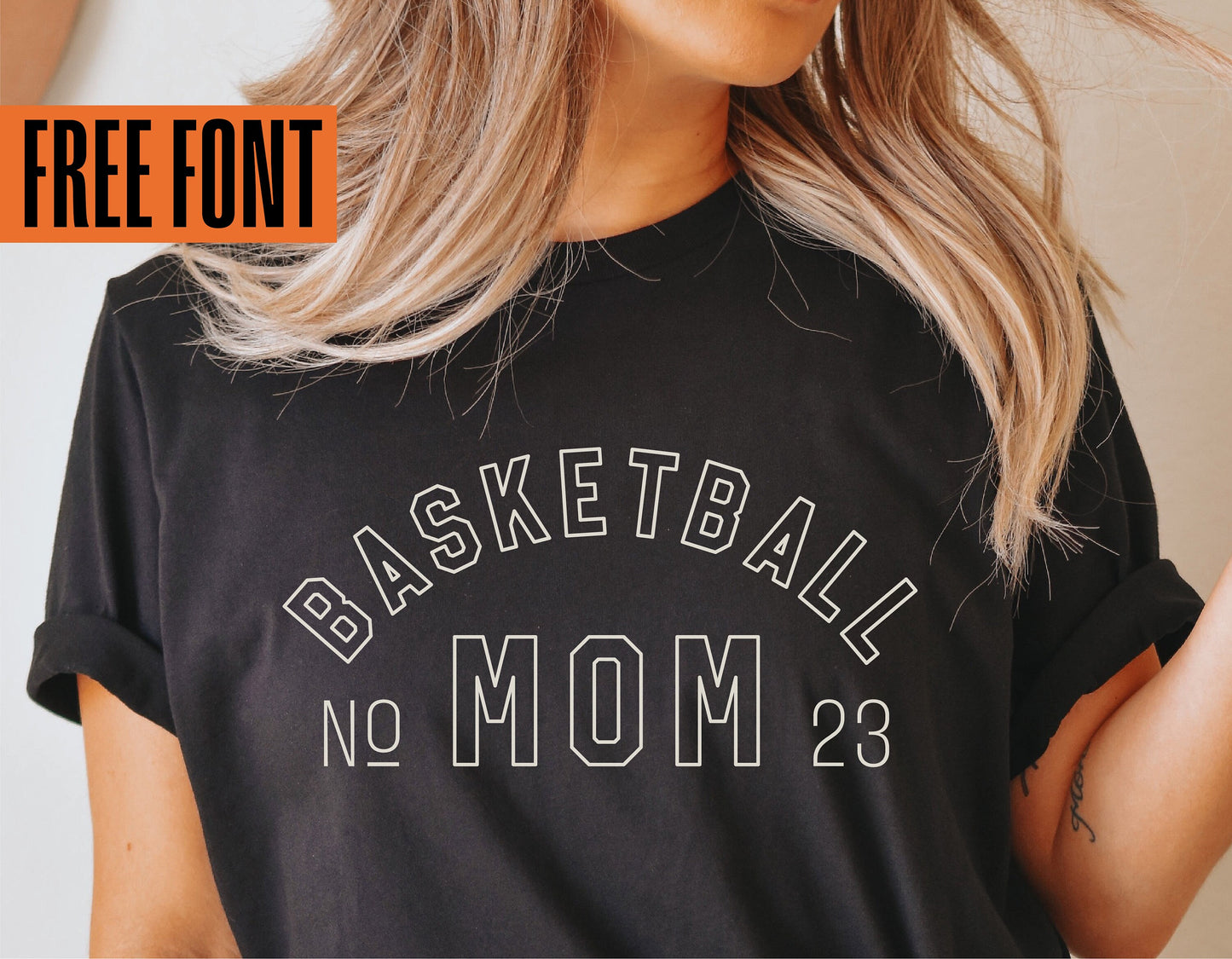 Woman wearing custom Basketball Mom shirt featuring 'No 23' design, showcasing free font for Cricut and sublimation projects.