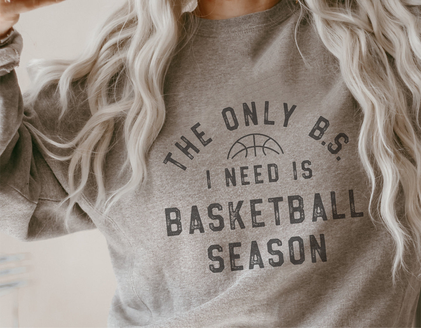 Cozy gray sweatshirt with 'The Only B.S. I Need is Basketball Season' printed text, perfect for basketball fans and sports enthusiasts.