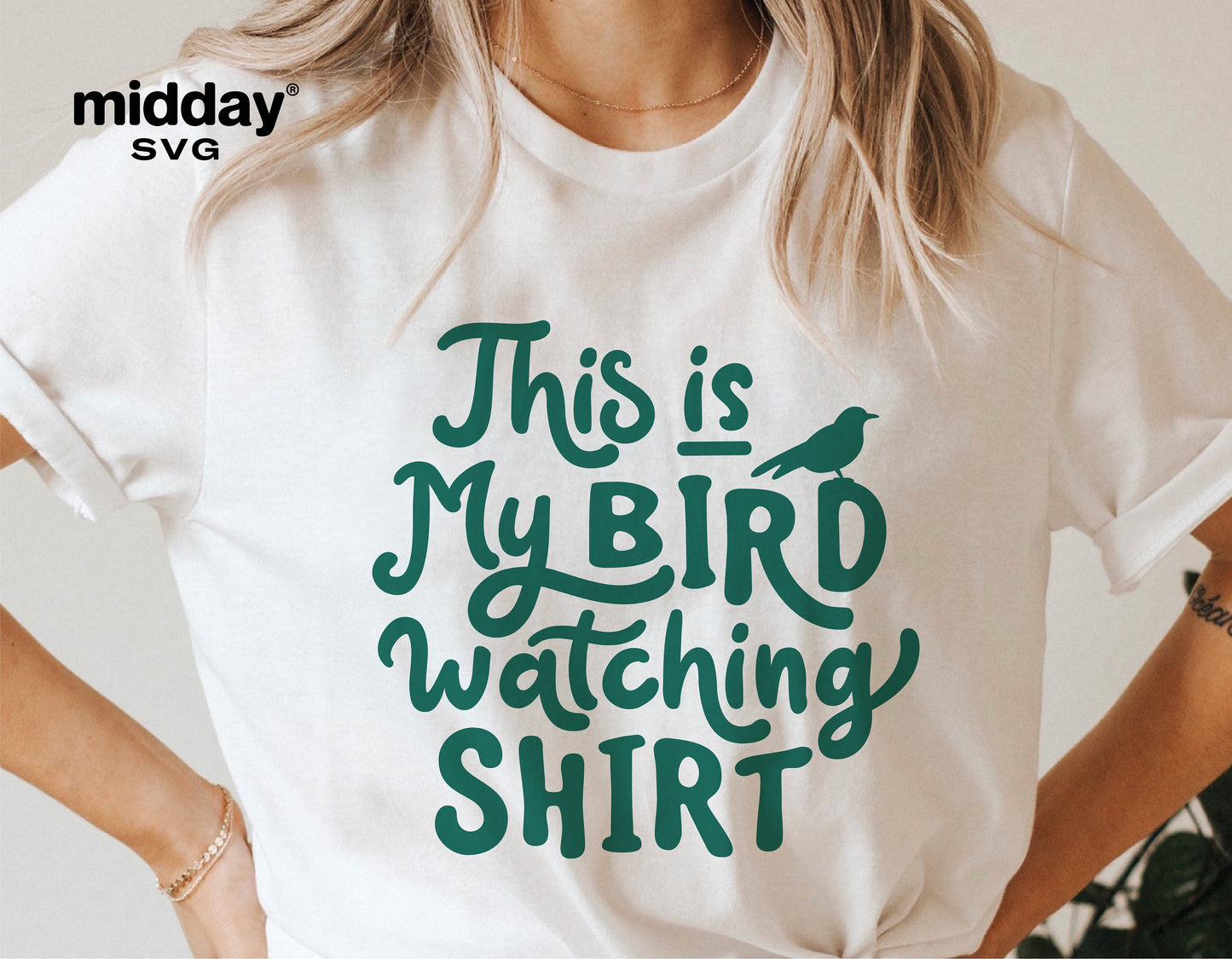 Woman wearing a white t-shirt with 'This is My Bird Watching Shirt' printed in green text, perfect for bird lovers and spring enthusiasts.