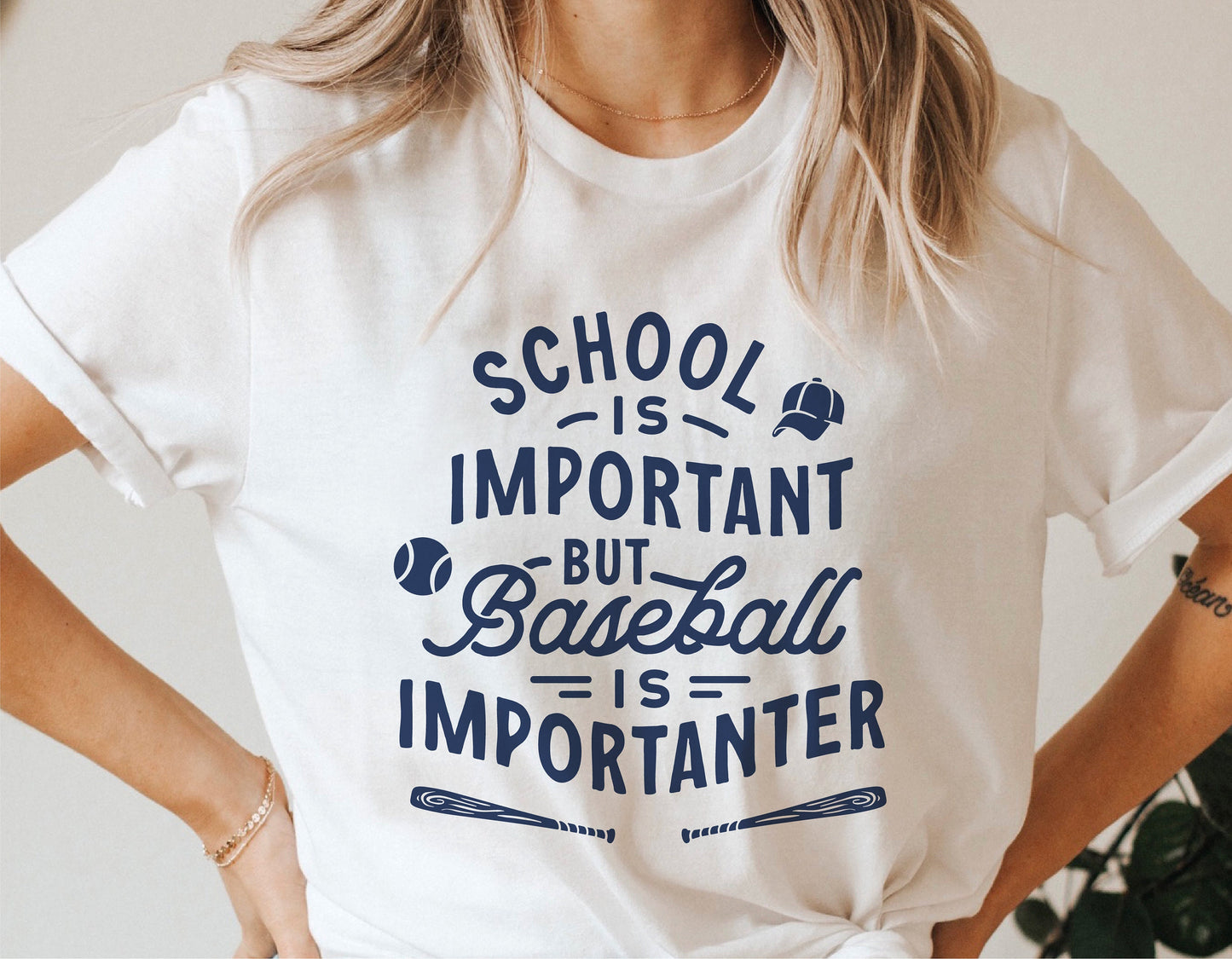 Woman wearing funny baseball shirt with 'School is important but baseball is importanter' text.