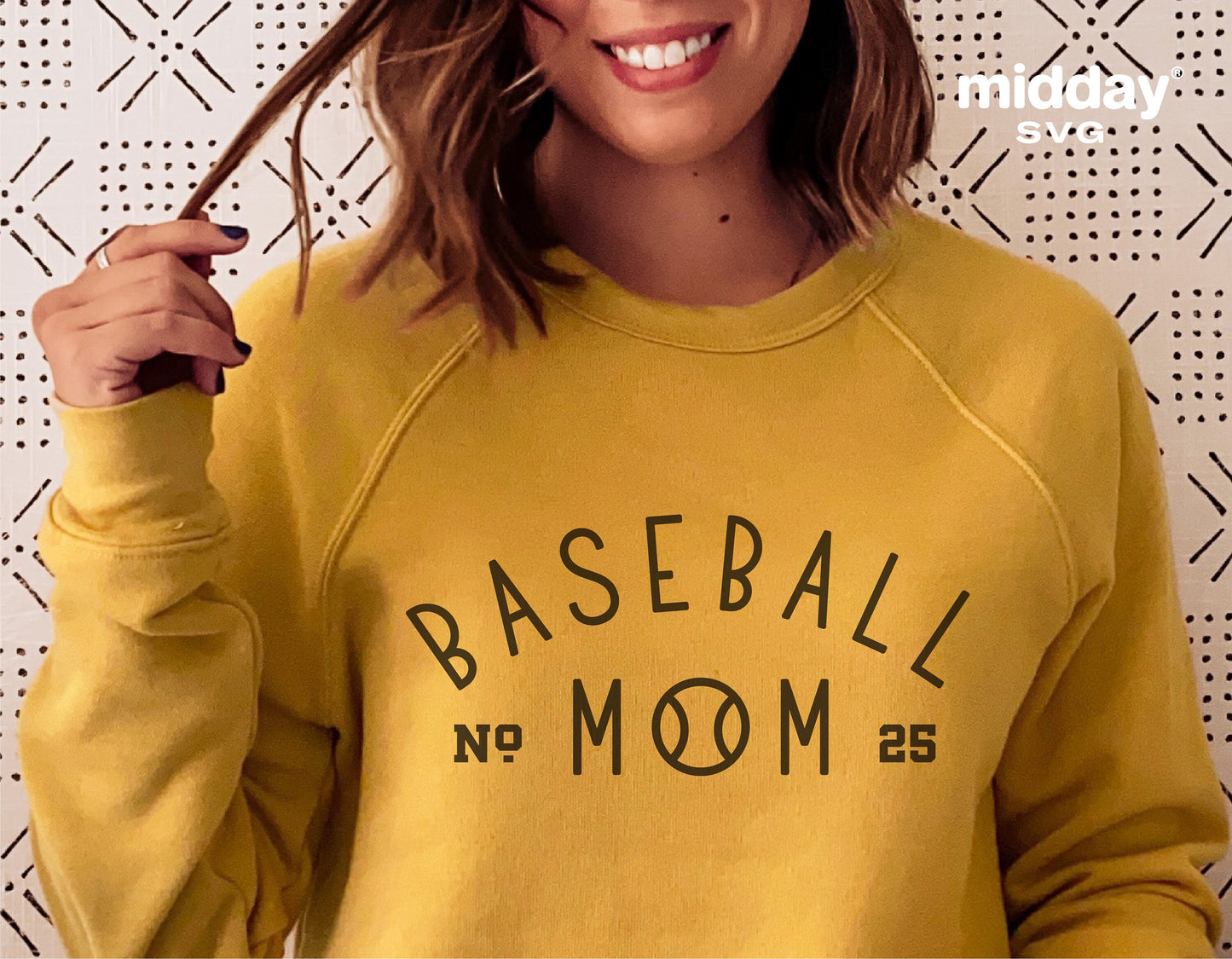 Person wearing a yellow sweatshirt with 'Baseball Mom No. 25' design, showcasing casual baseball-themed apparel.