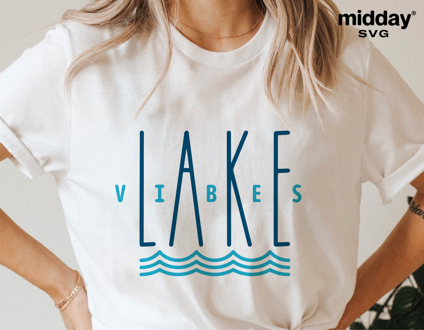 Woman wearing a white t-shirt with 'Lake Vibes' design in blue, perfect for lake vacations and summer camping.