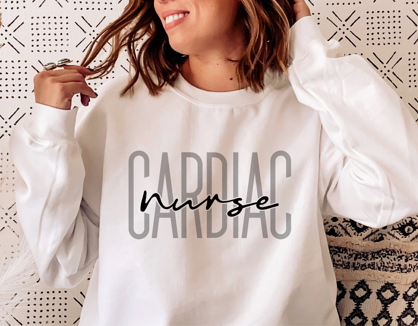 White sweater featuring 'Cardiac Nurse' text in bold, styled for nurses, perfect for Cricut and Silhouette cutting projects.